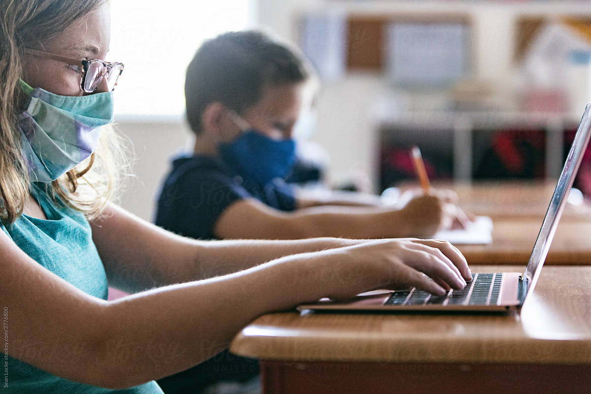 School: Girl With Glasses And Face Mask Works On Computer