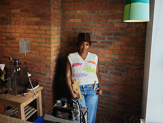 Black Woman Hat Maker In A Workshop Space, Sews On A Sewing Machine by  Stocksy Contributor Iryna Shepetko - Stocksy