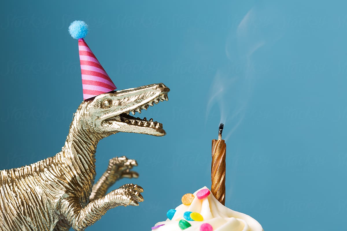 Birthday cake and toy dinosaur