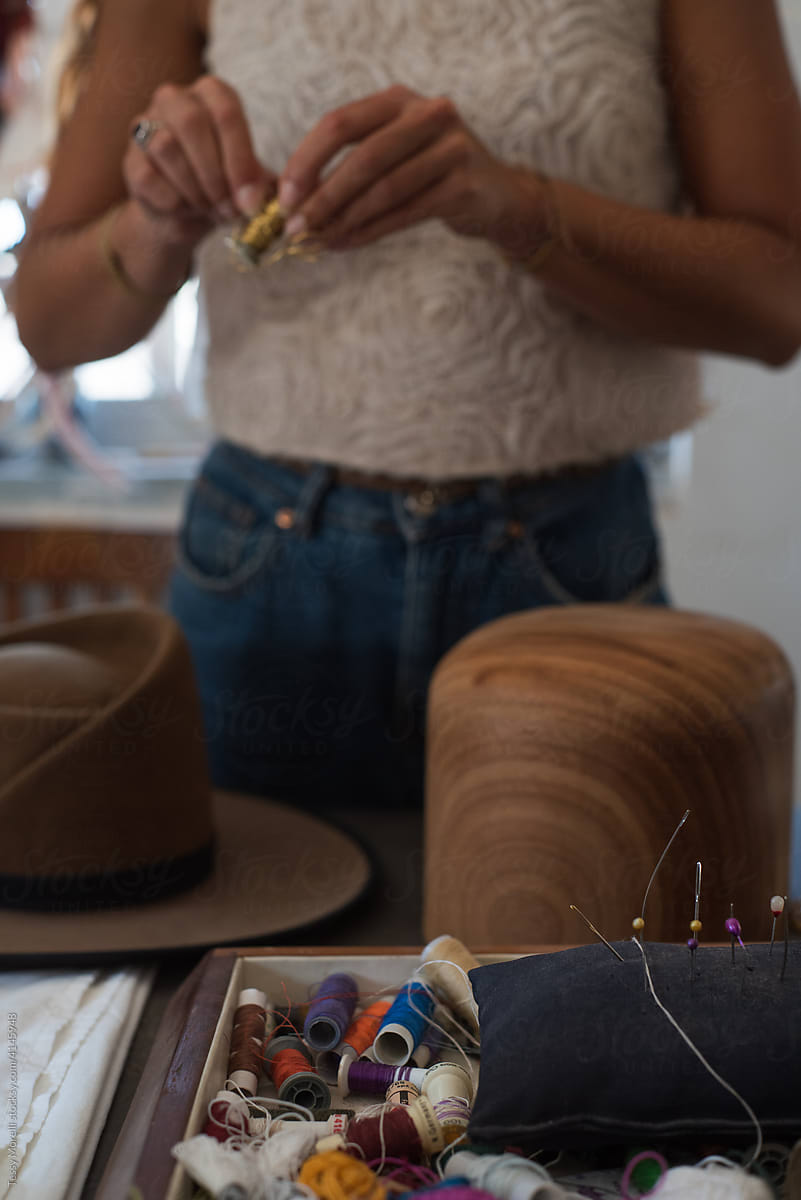 Designer in the process of shaping a hat with a block