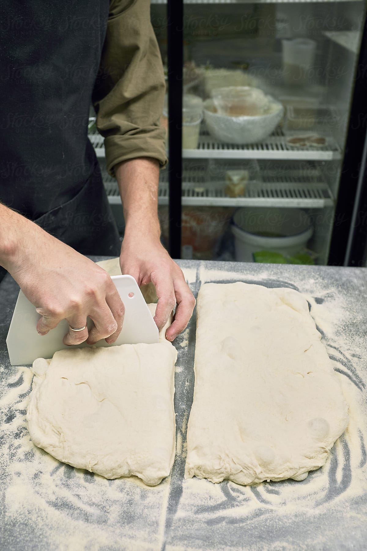 Baker cutting ciabatta dough