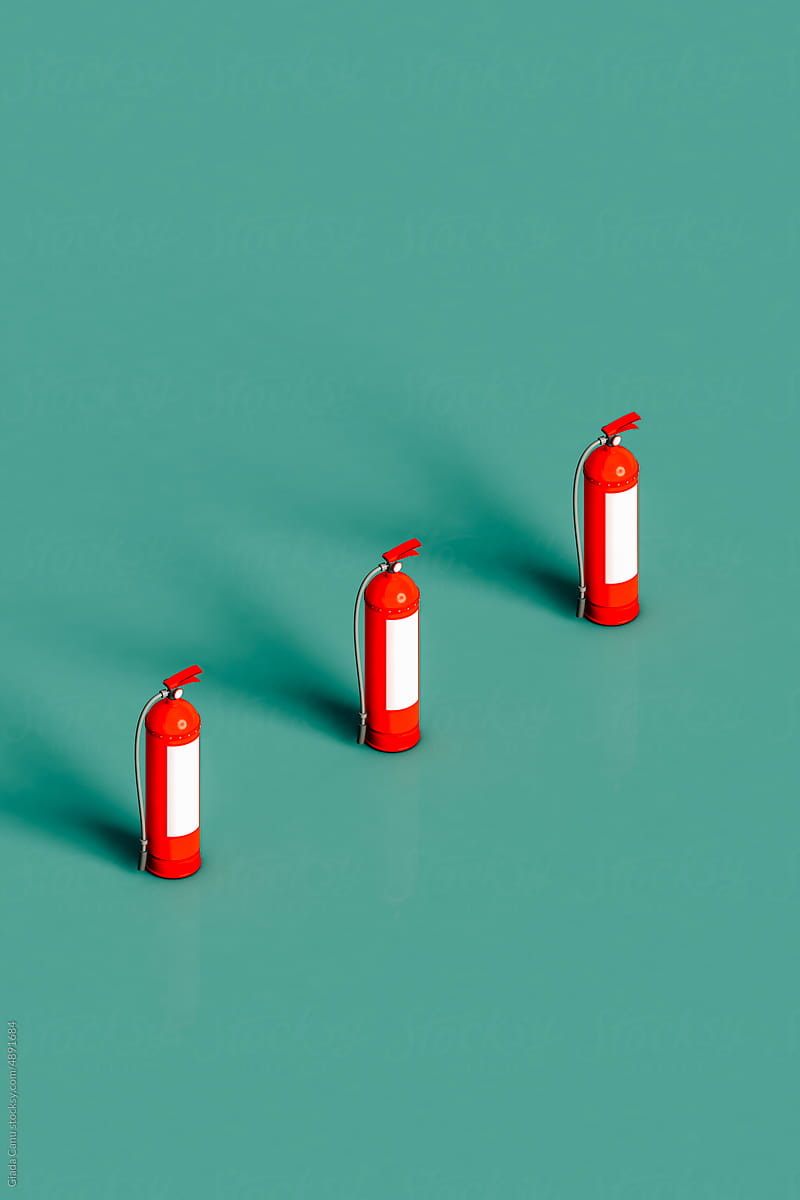 three red fire extinguishers on green background