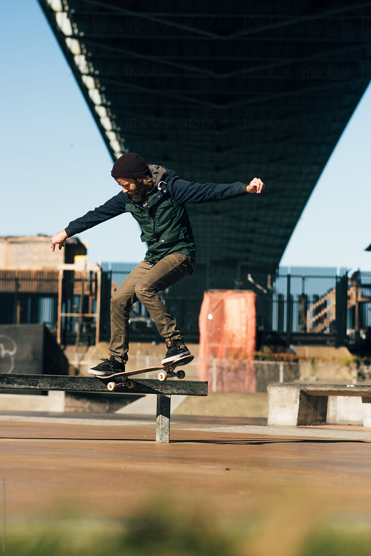 Skateboarder under bridge
