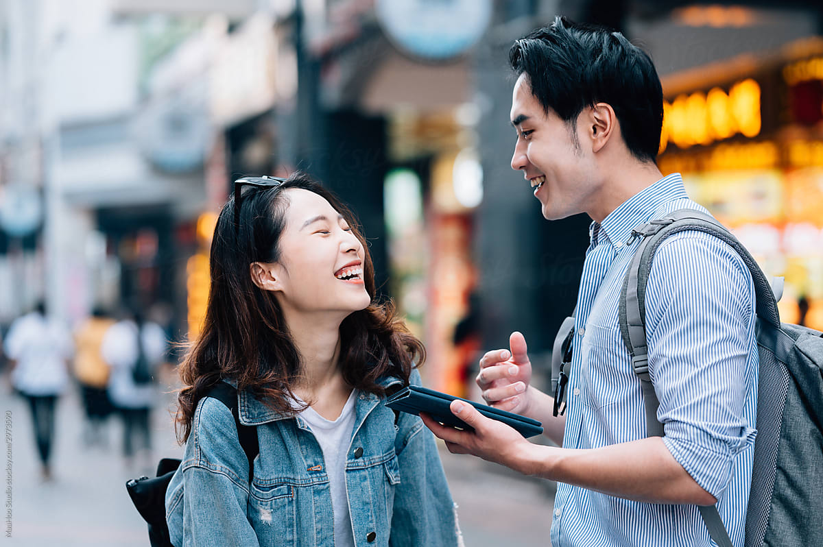 Young couple talking and laughing in street