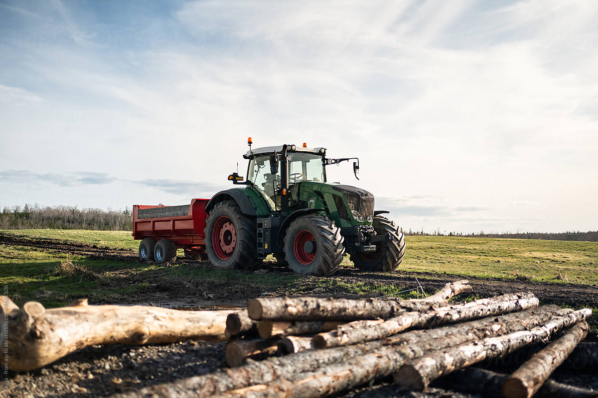 tractor on a farm with logs