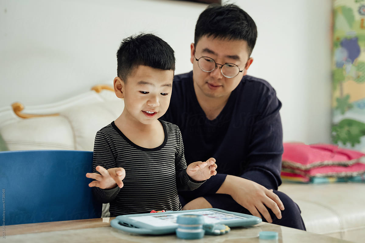 Asian father and toddler son at home