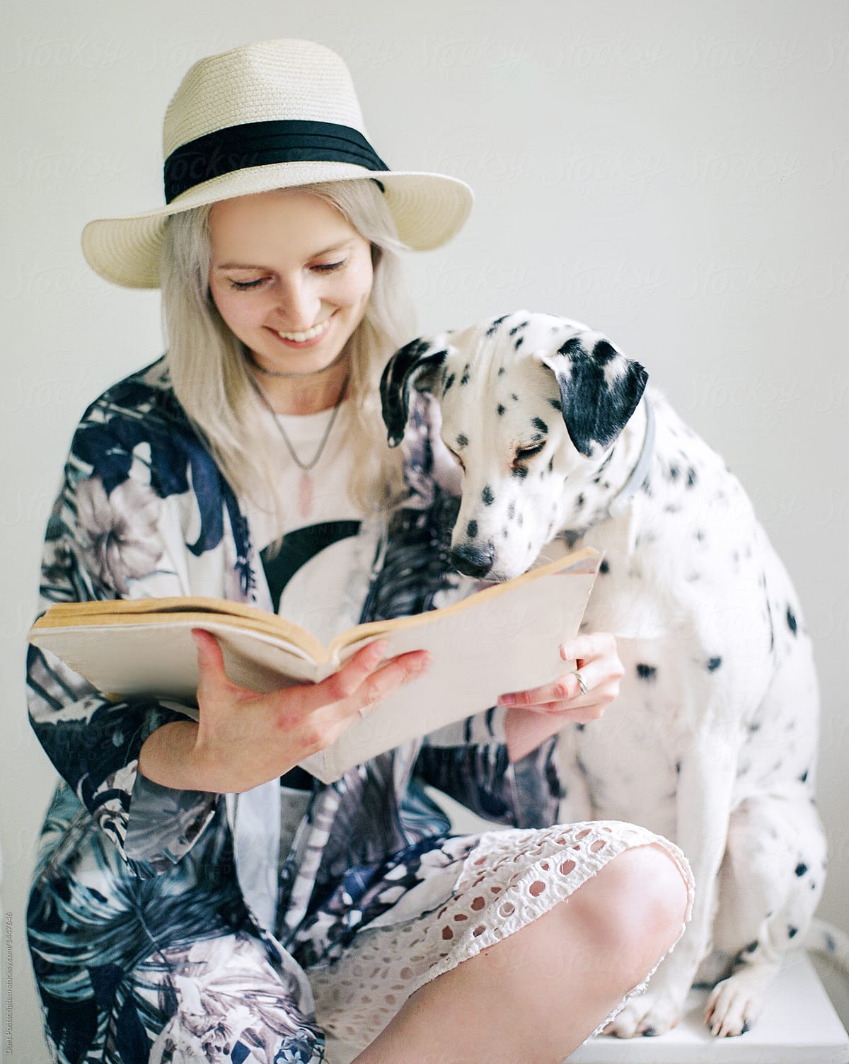 Woman and dog reading magazine