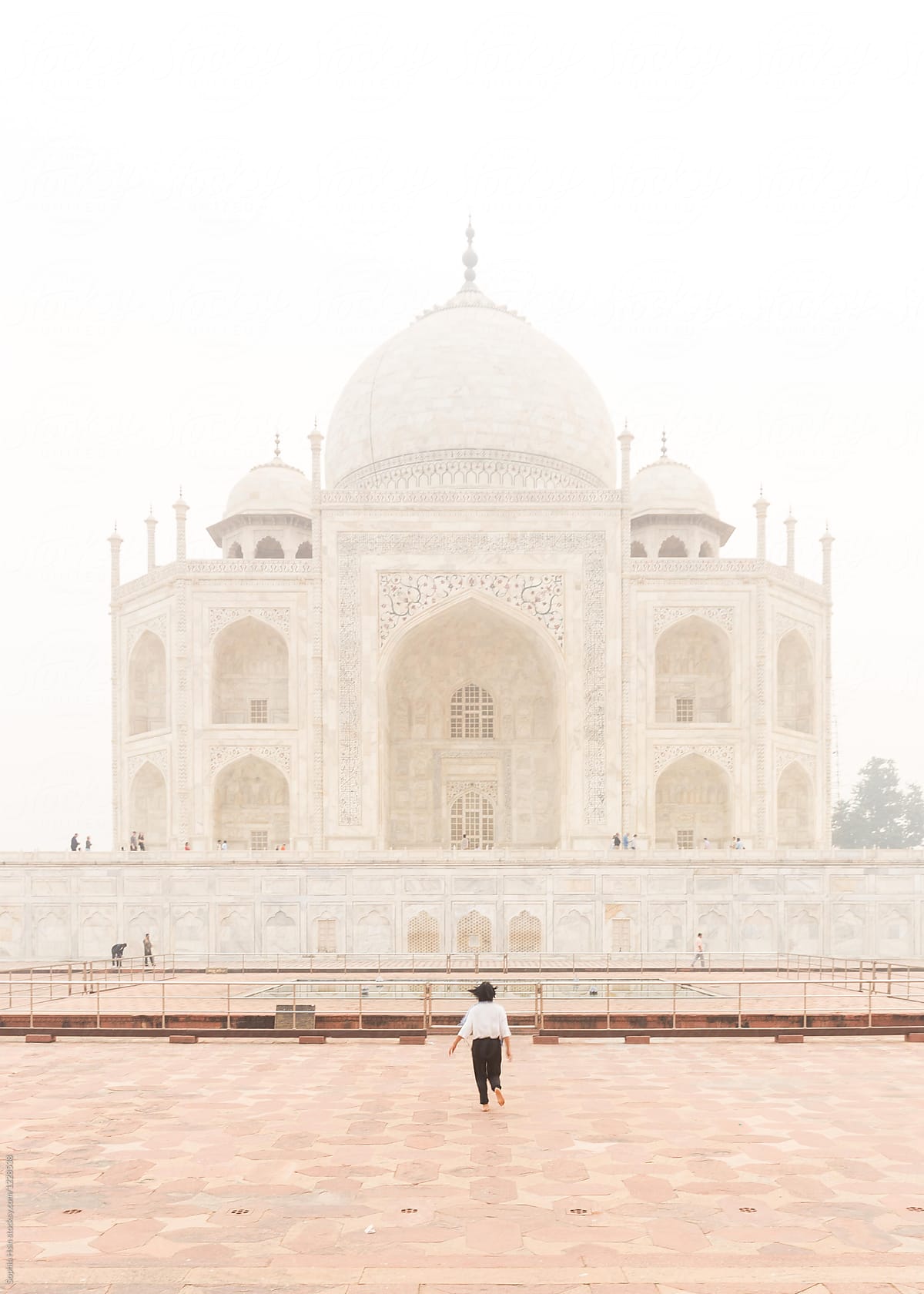 Girl running towards the Taj Mahal, Agra, India