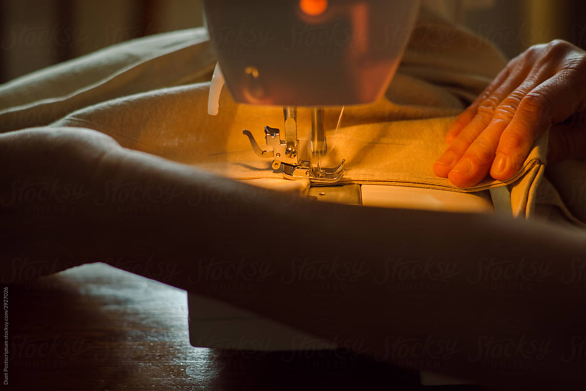 Elderly woman\'s hands while sewing
