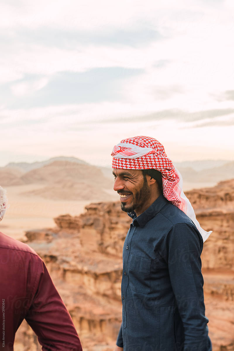 Arabic man smiling in the desert.