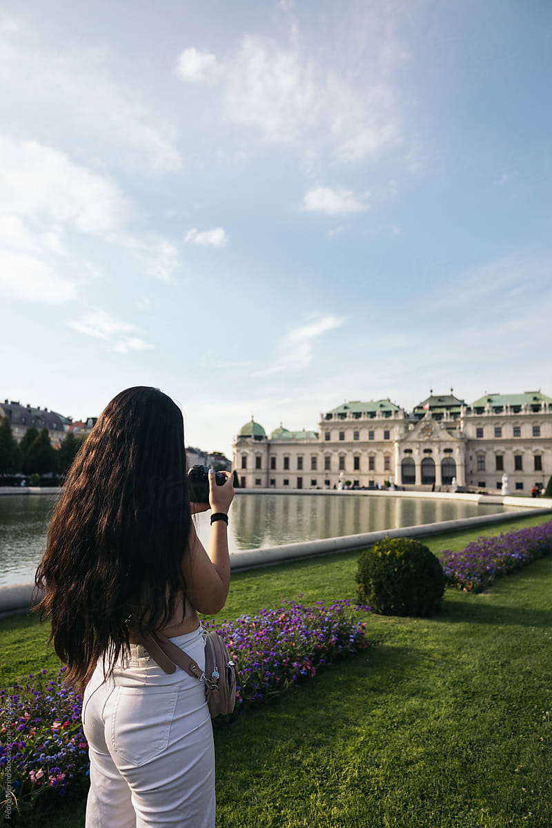 Woman taking photos at Belvedere Palace in Vienna