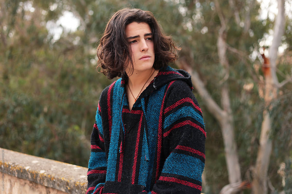 Bohemian teenage boy with long hair outdoors por Lucas Ottone ...