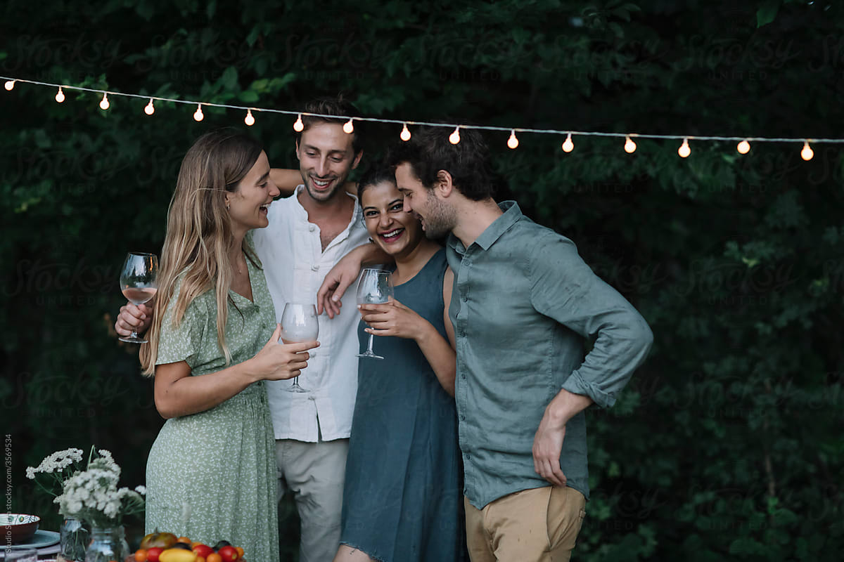 Friends Holding each other at a Backyard Dinner Party