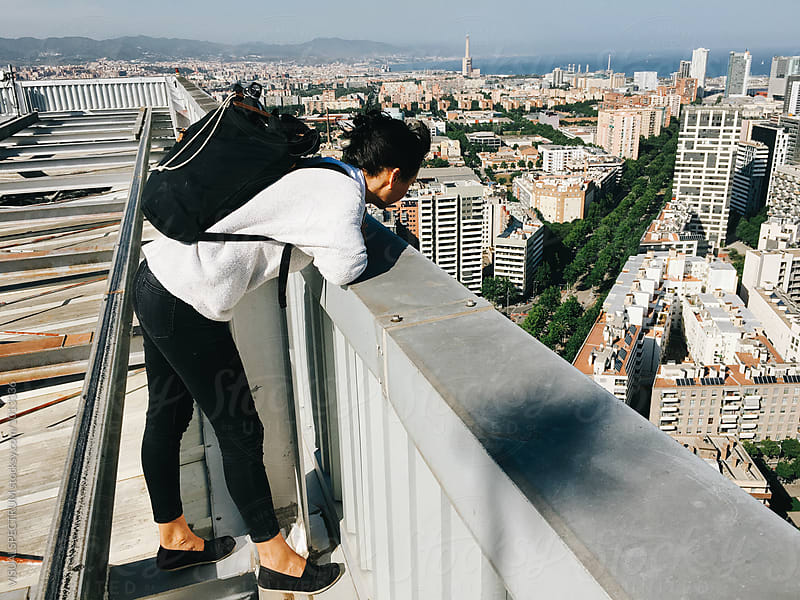 Woman Standing on Barcelona Skyscraper and Loooking Down