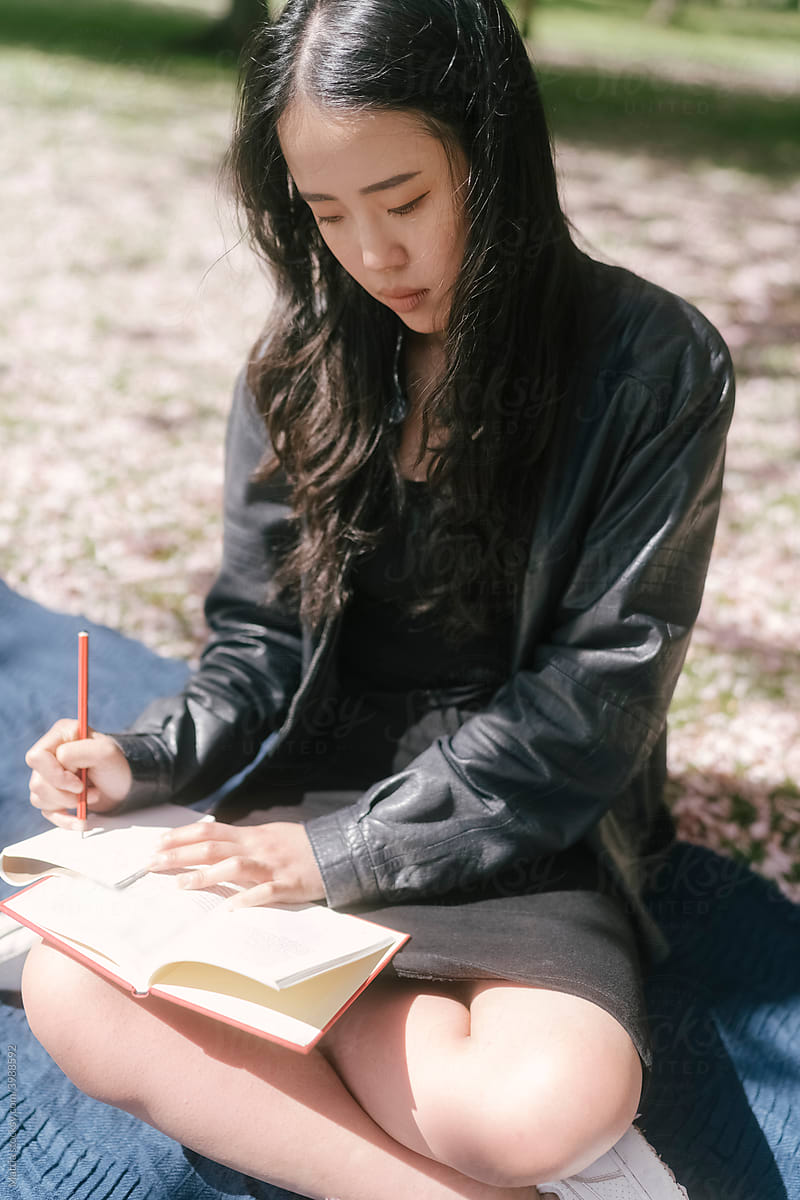 Asian woman Studying in the Park