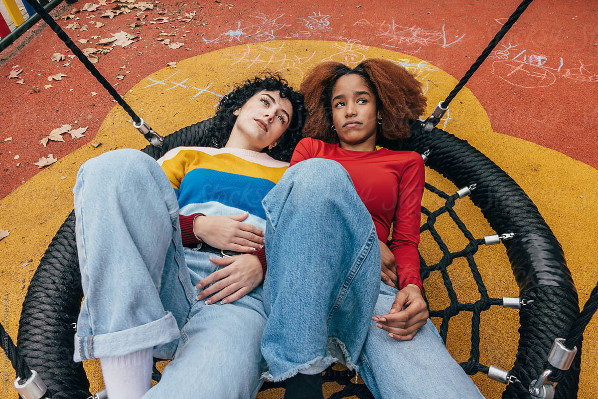 Young girls relaxing on urban playground in Madrid