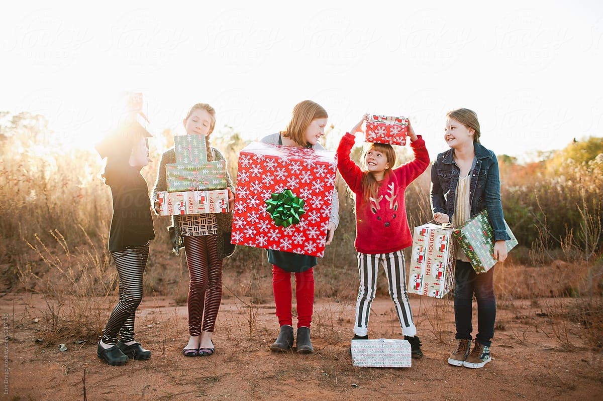 Girls holding Christmas Gifts