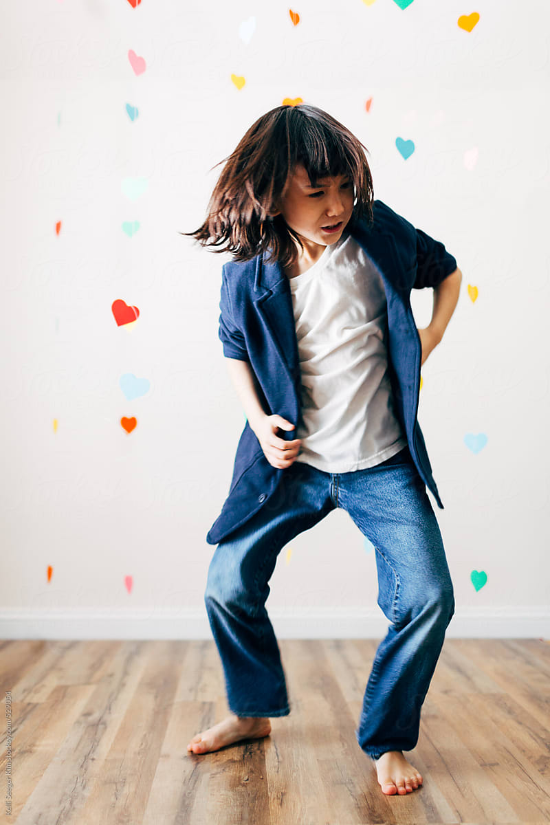 Young boy happily dancing alone