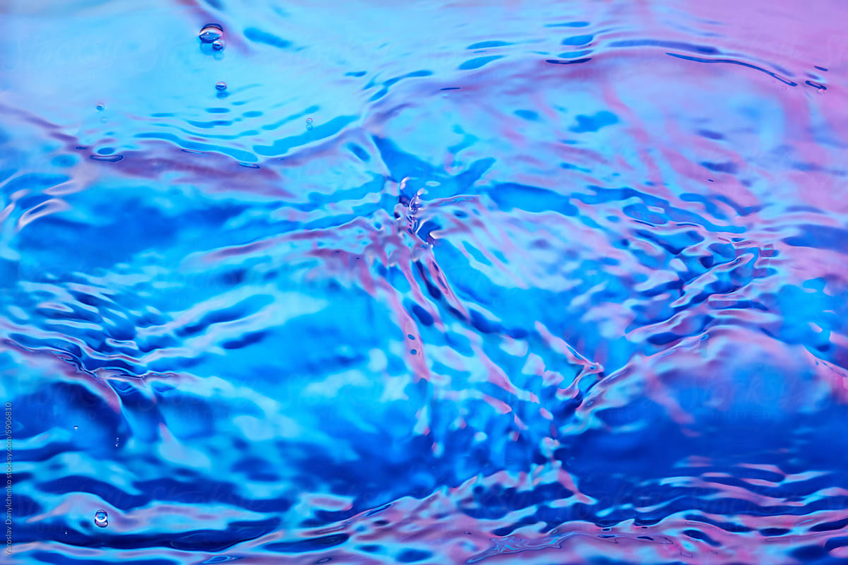 Splashing of water with blue and pink color gradient on surface