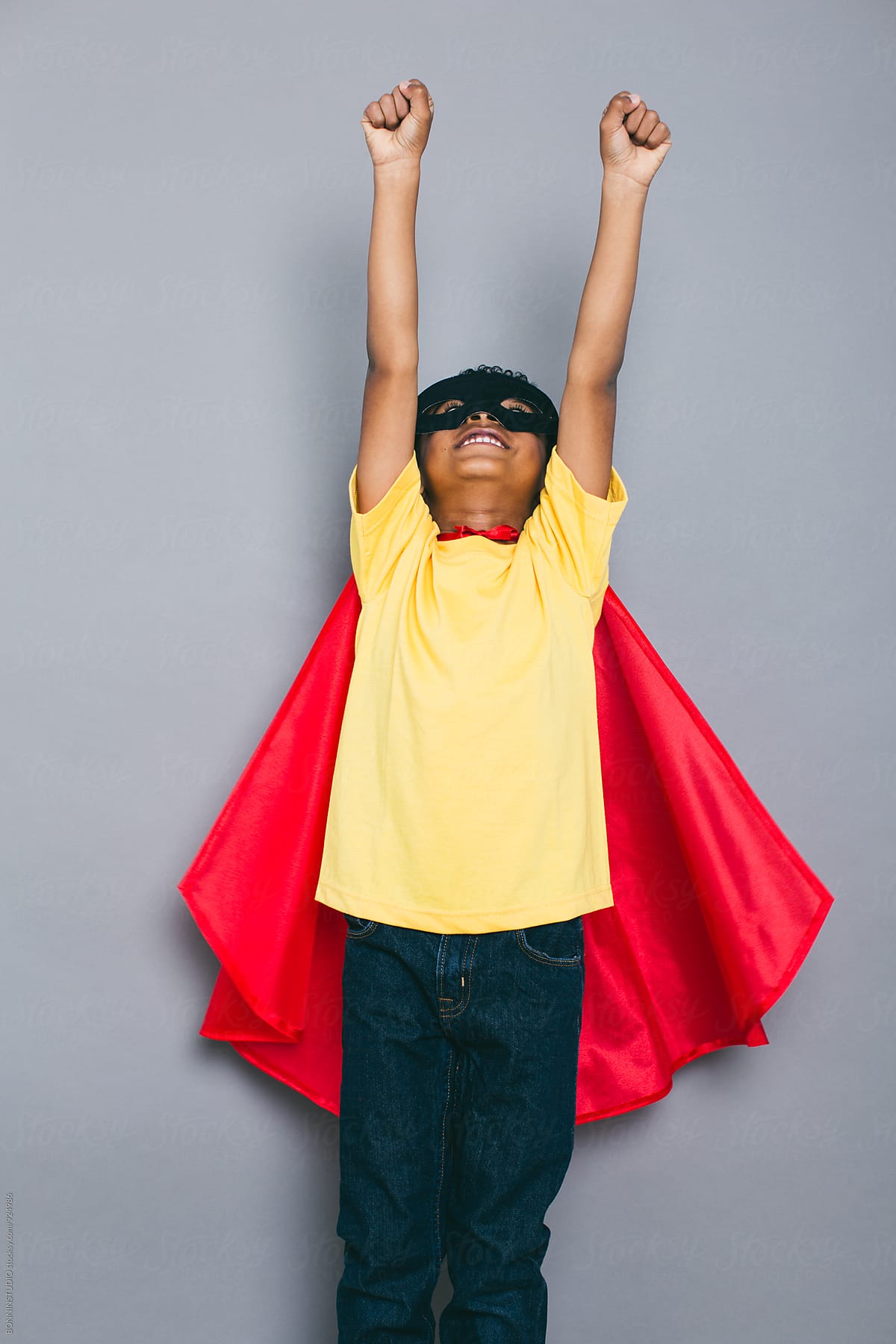 Funny little boy with Superhero costume.