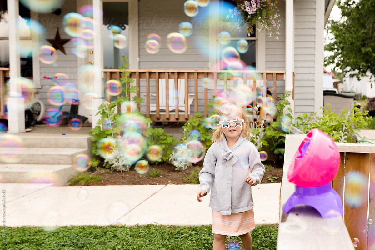 Girl in sunglasses with bubble machine