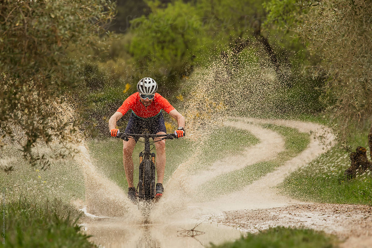cyclist crossing a puddle of water