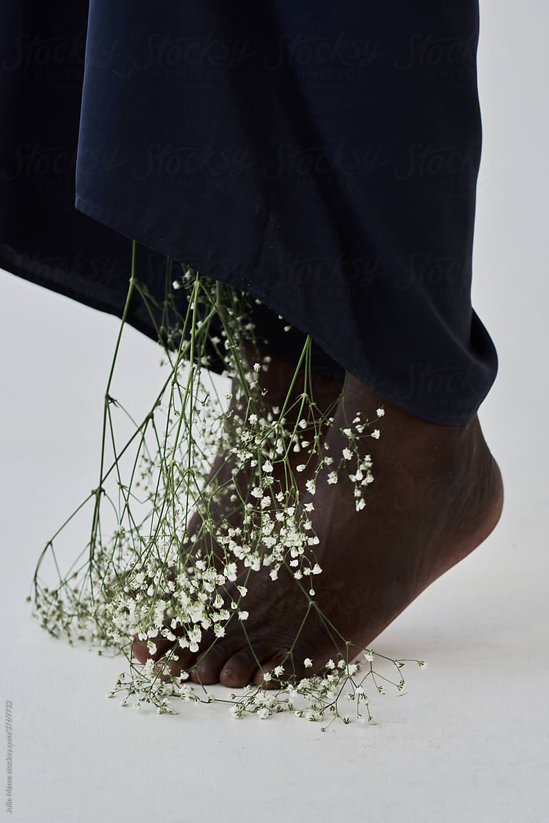 African legs and flowers growing from the pants