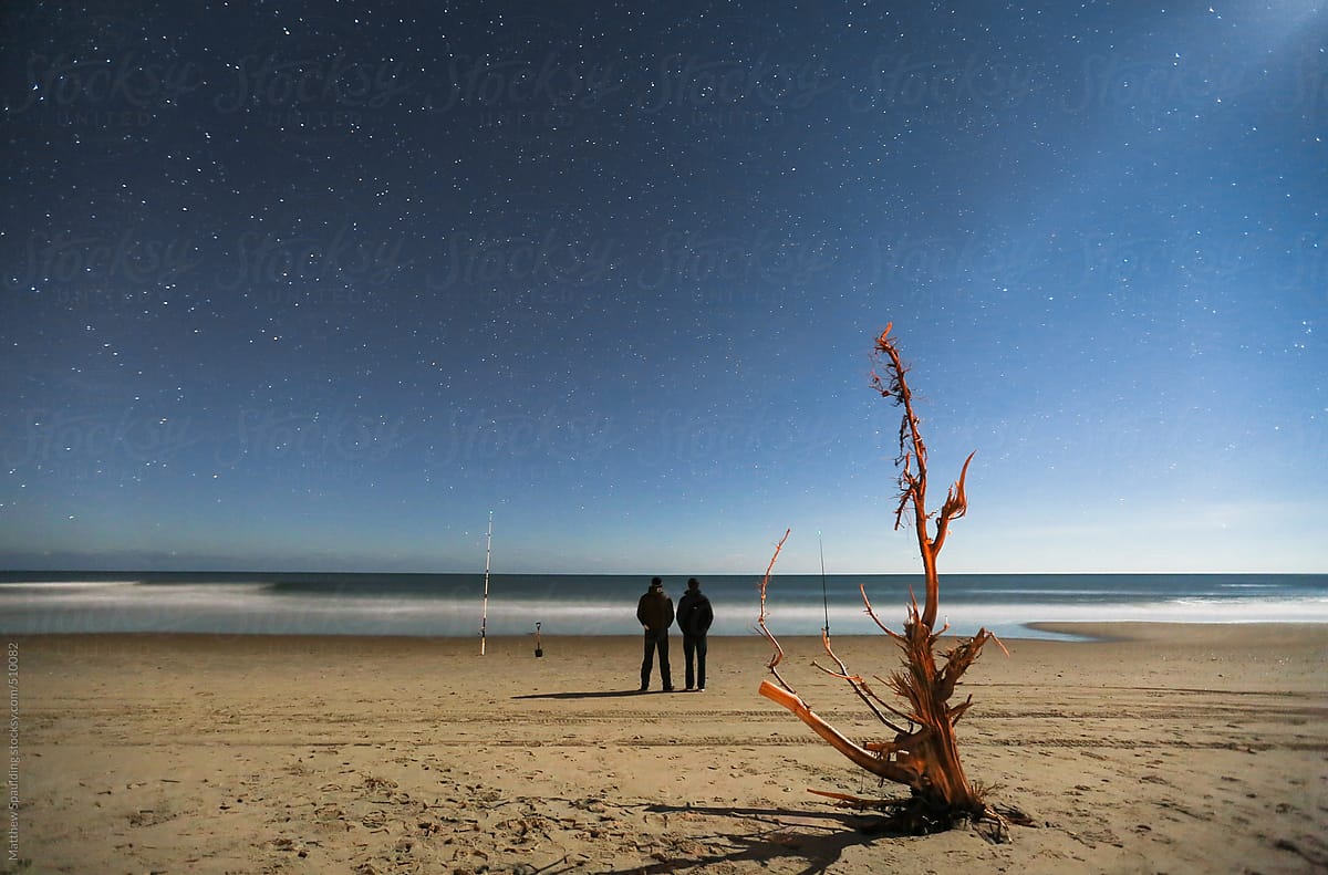 Two People Standing On Beach Under Night Sky Stars by Stocksy Contributor Matthew  Spaulding - Stocksy