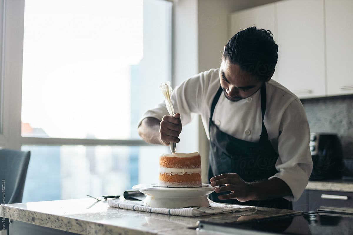 pastry chef assembling a cake