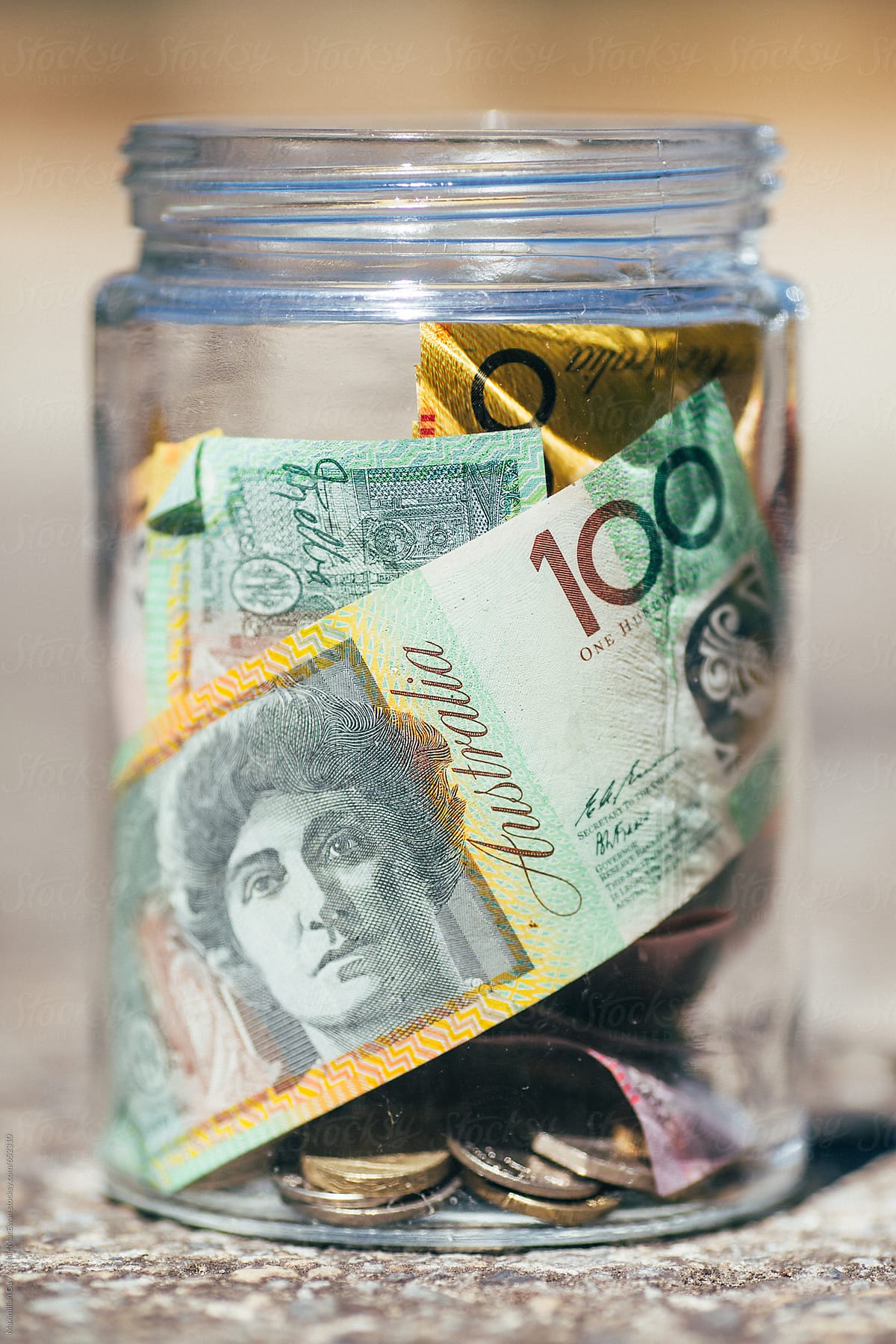 A glass jar of Australian dollars