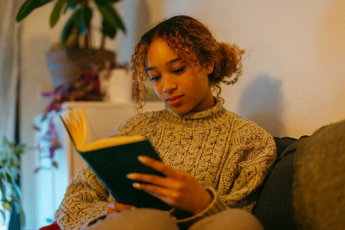Young woman reading on the couch