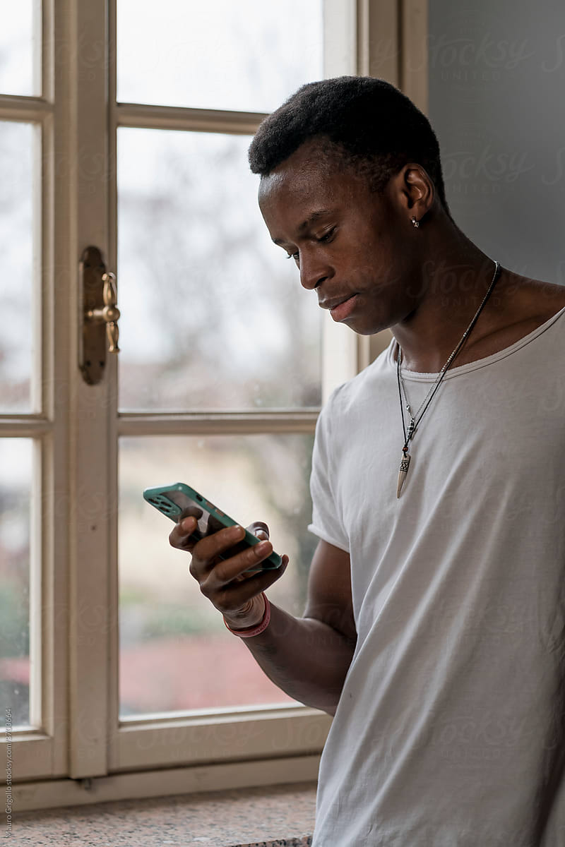 Black man At Home using a mobile phone