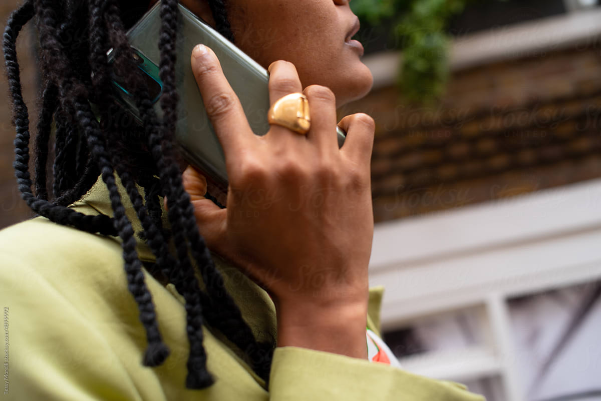 Candid detail of black woman on phone call