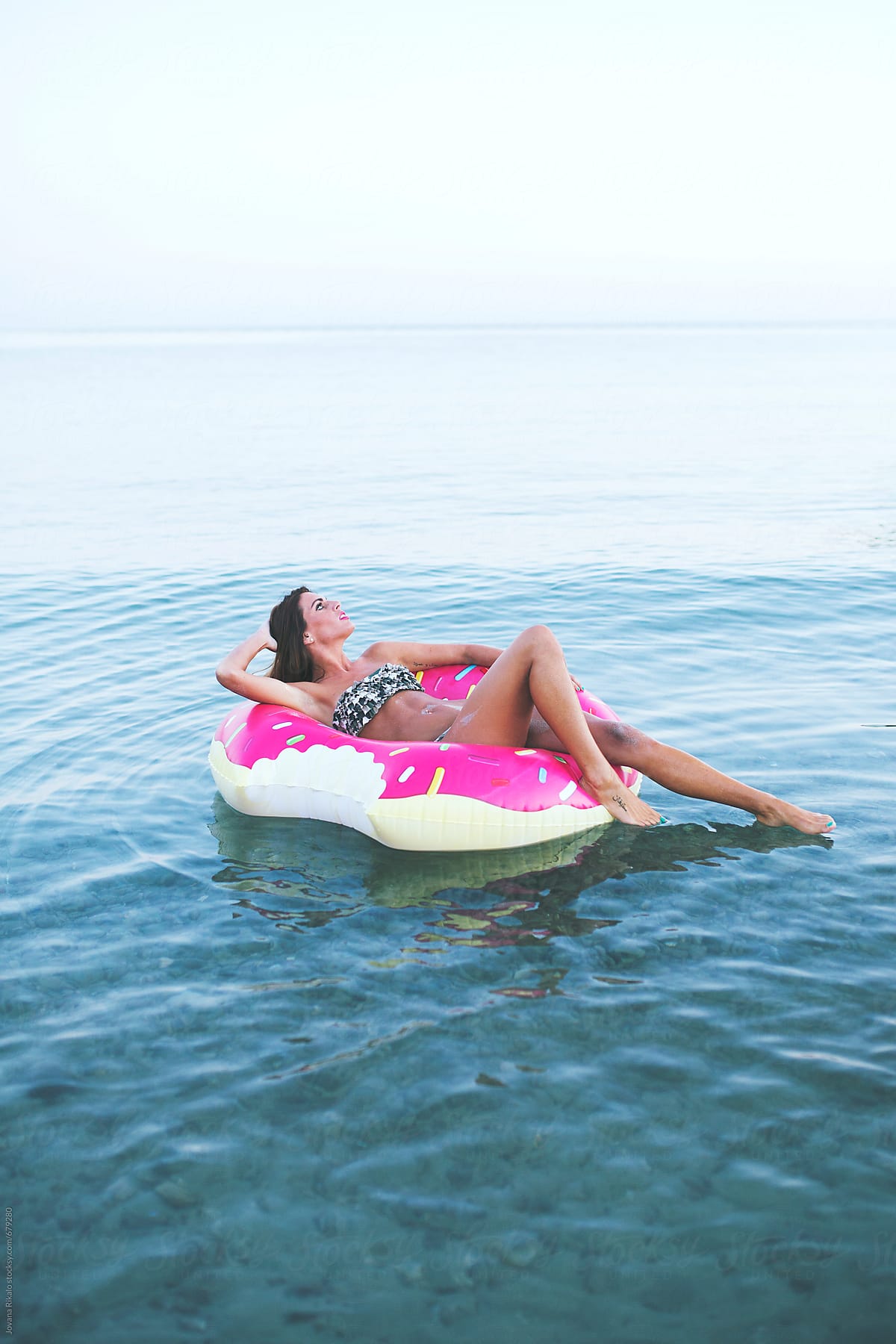 Woman floating on inflatable tube in the sea