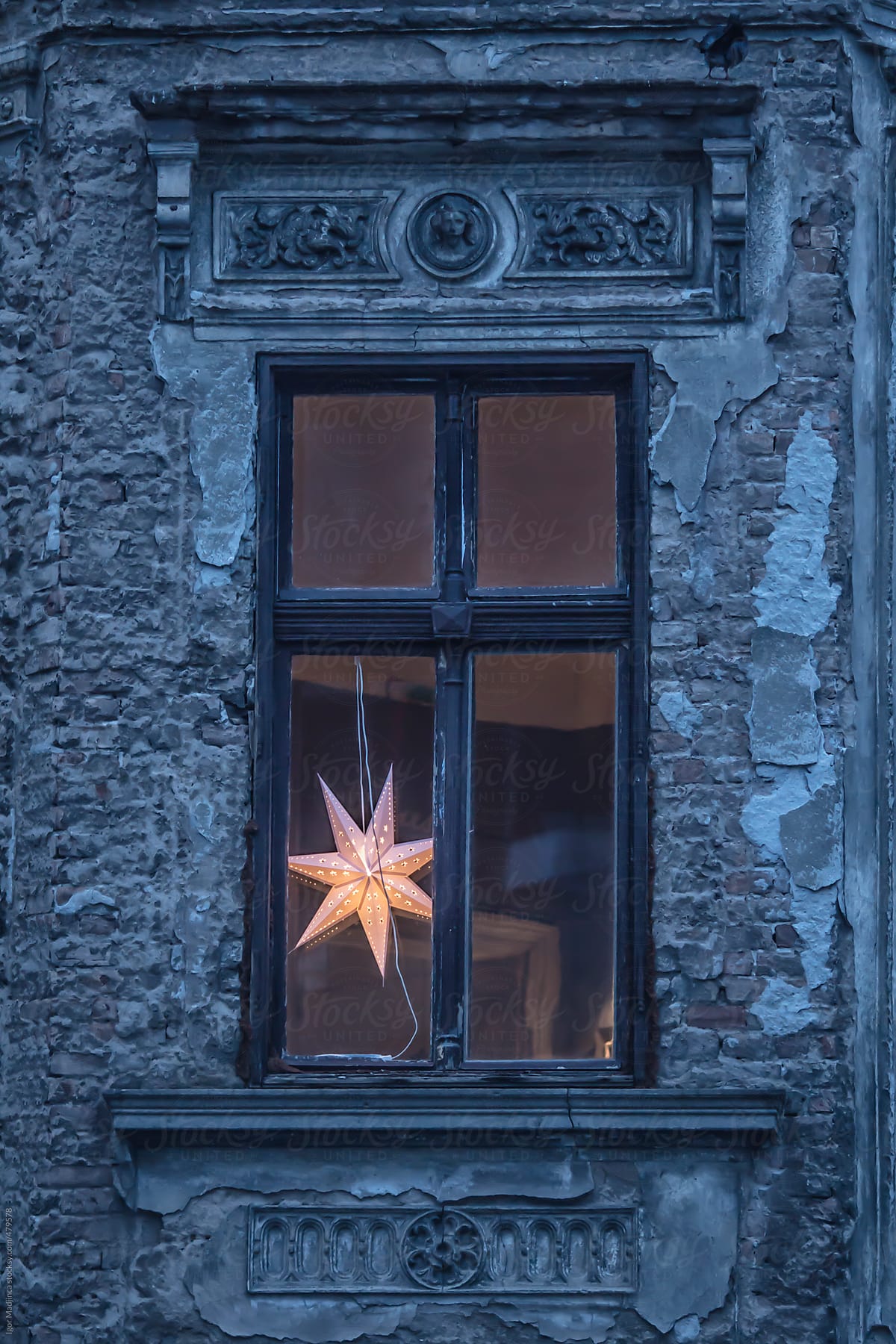 old facade, early  morning, New Year\'s window with modern lighting, star