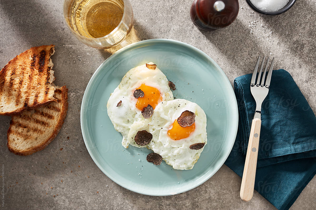 Breakfast with fried eggs on plate and toasts