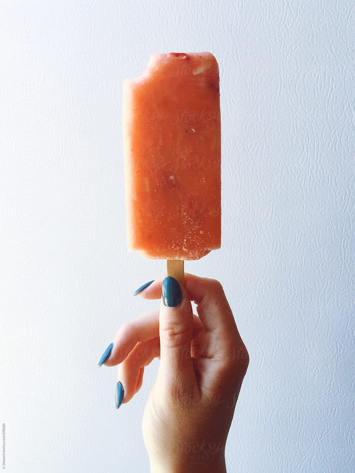 Hand holding Popsicle.