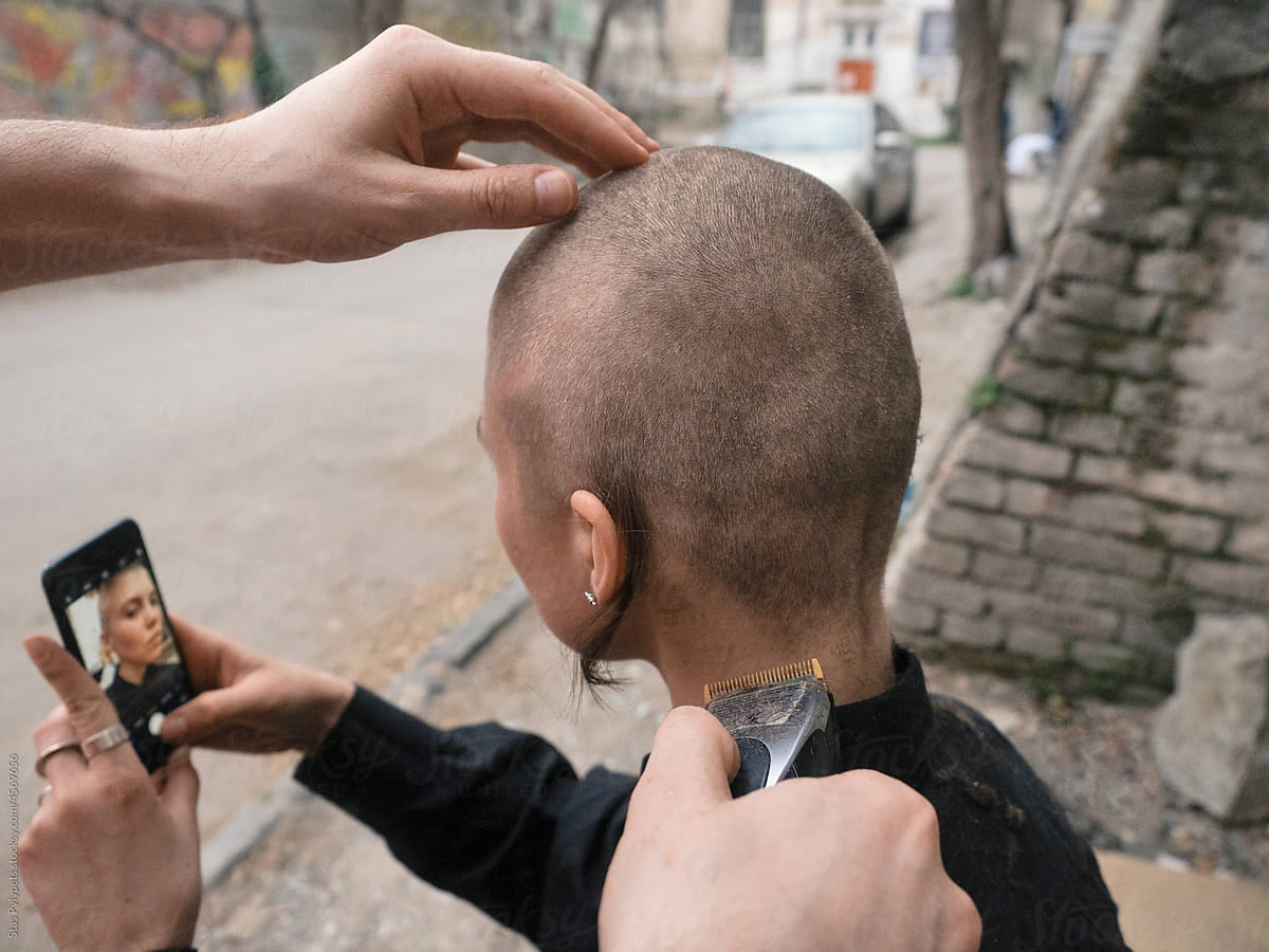 A young girl is cut bald