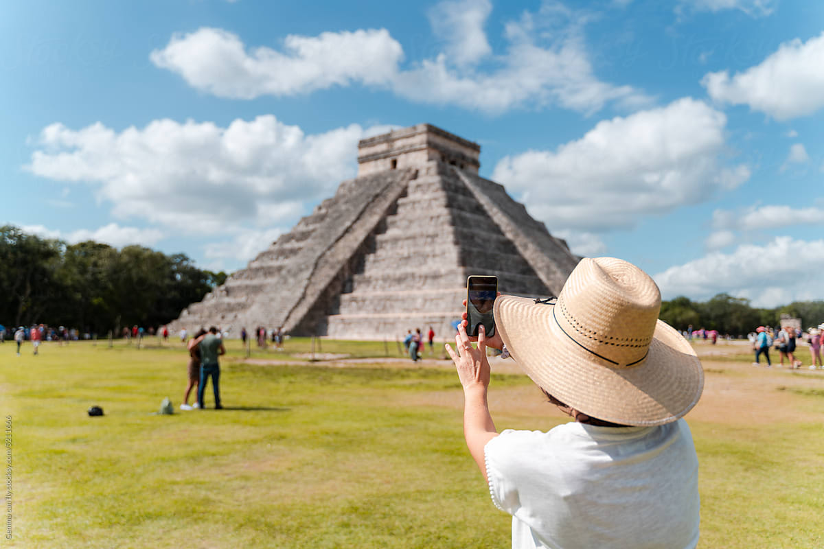 Woman taking mobile photos in Chichen Itzá, Mexico