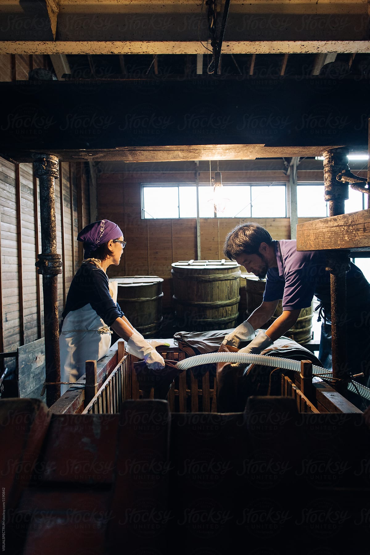 Japanese Man and Woman at Work in Traditional Soy Sauce Factory