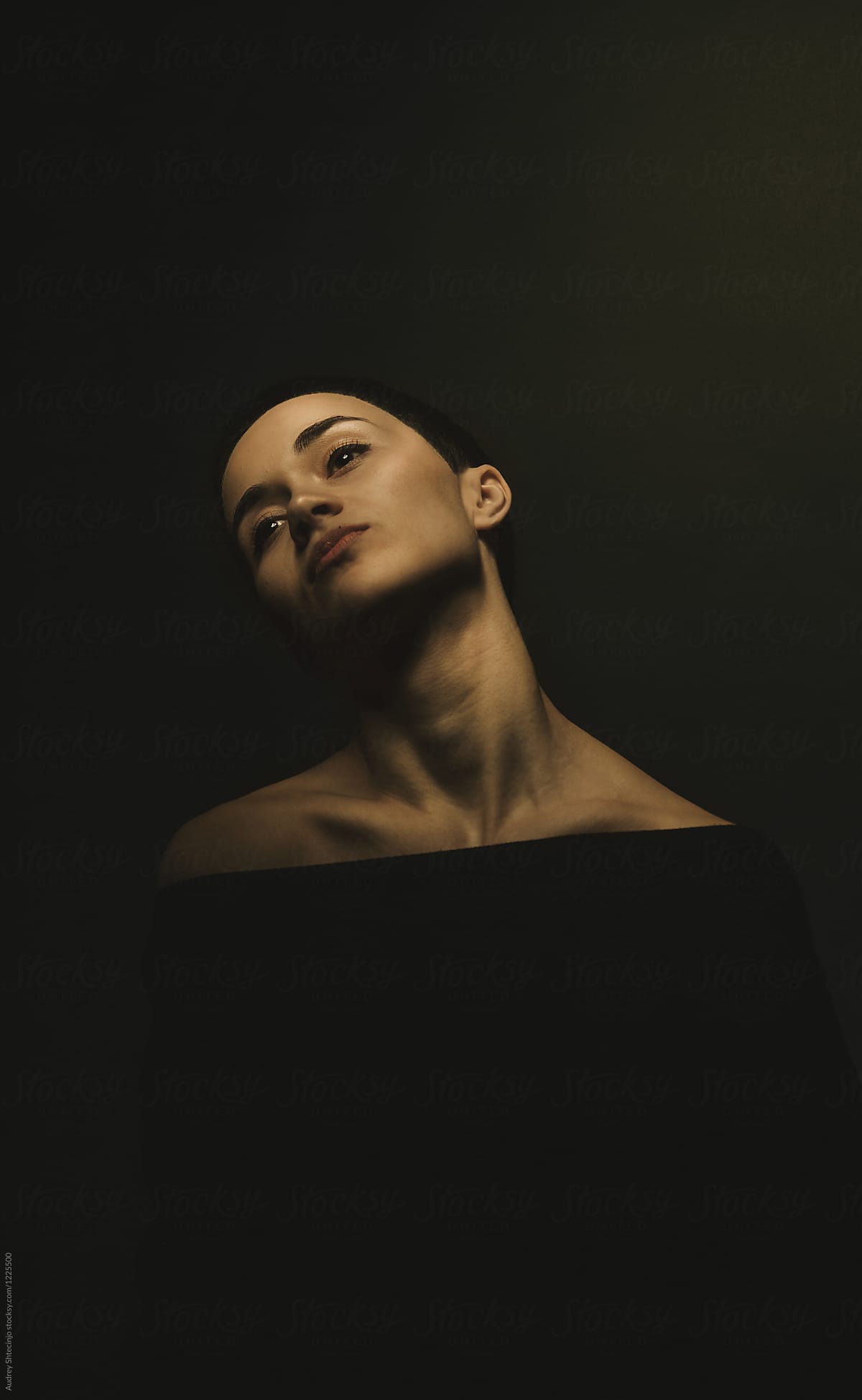 Dark/calm portrait of young woman with dark short hair