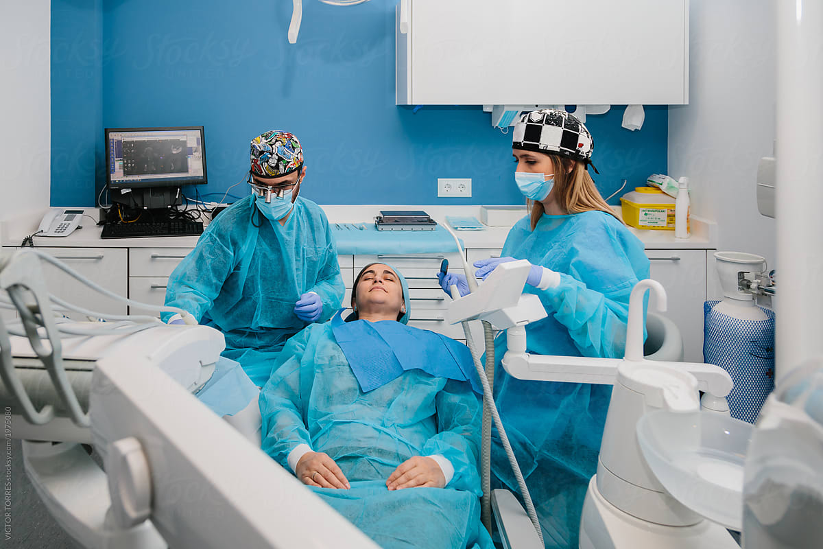 Dentists working on patient during a dental therapy