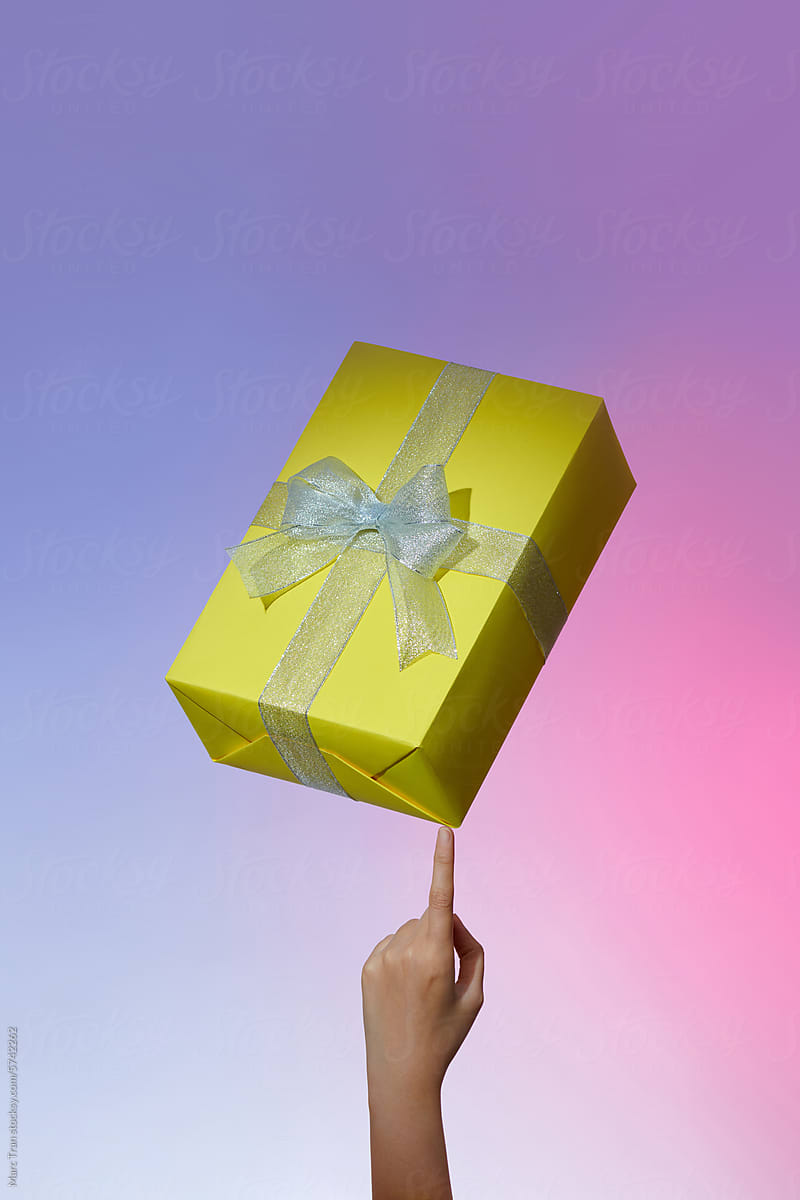 Gift boxes balanced on a finger