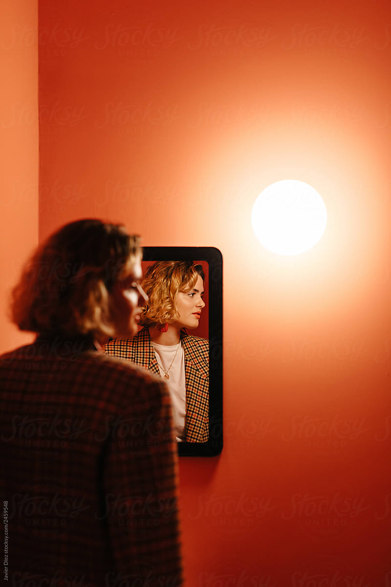Woman standing near mirror