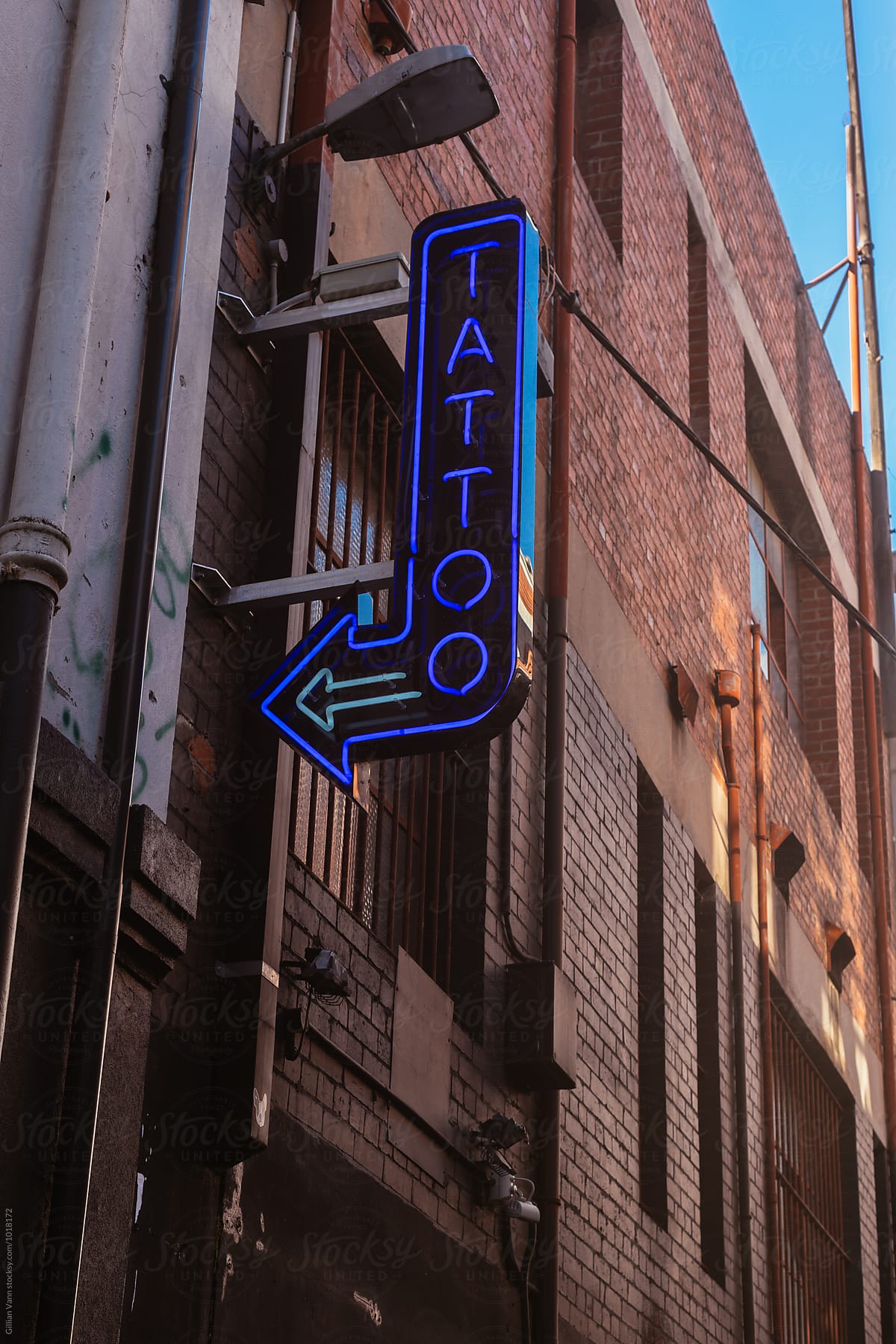 neon tattoo sign with arrow