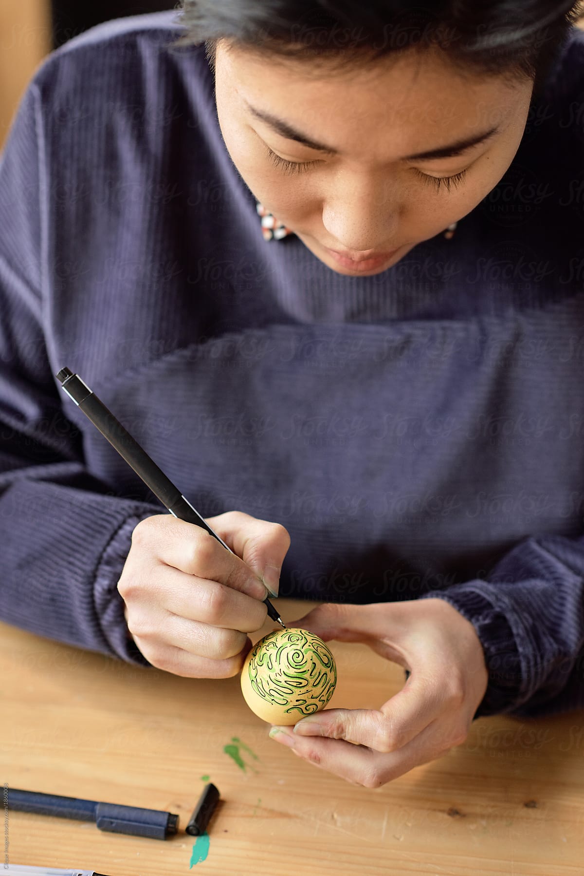 Creative woman painting egg