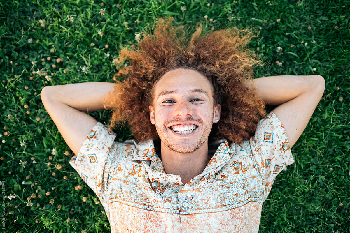 Portrait of Smiling man lying on grass