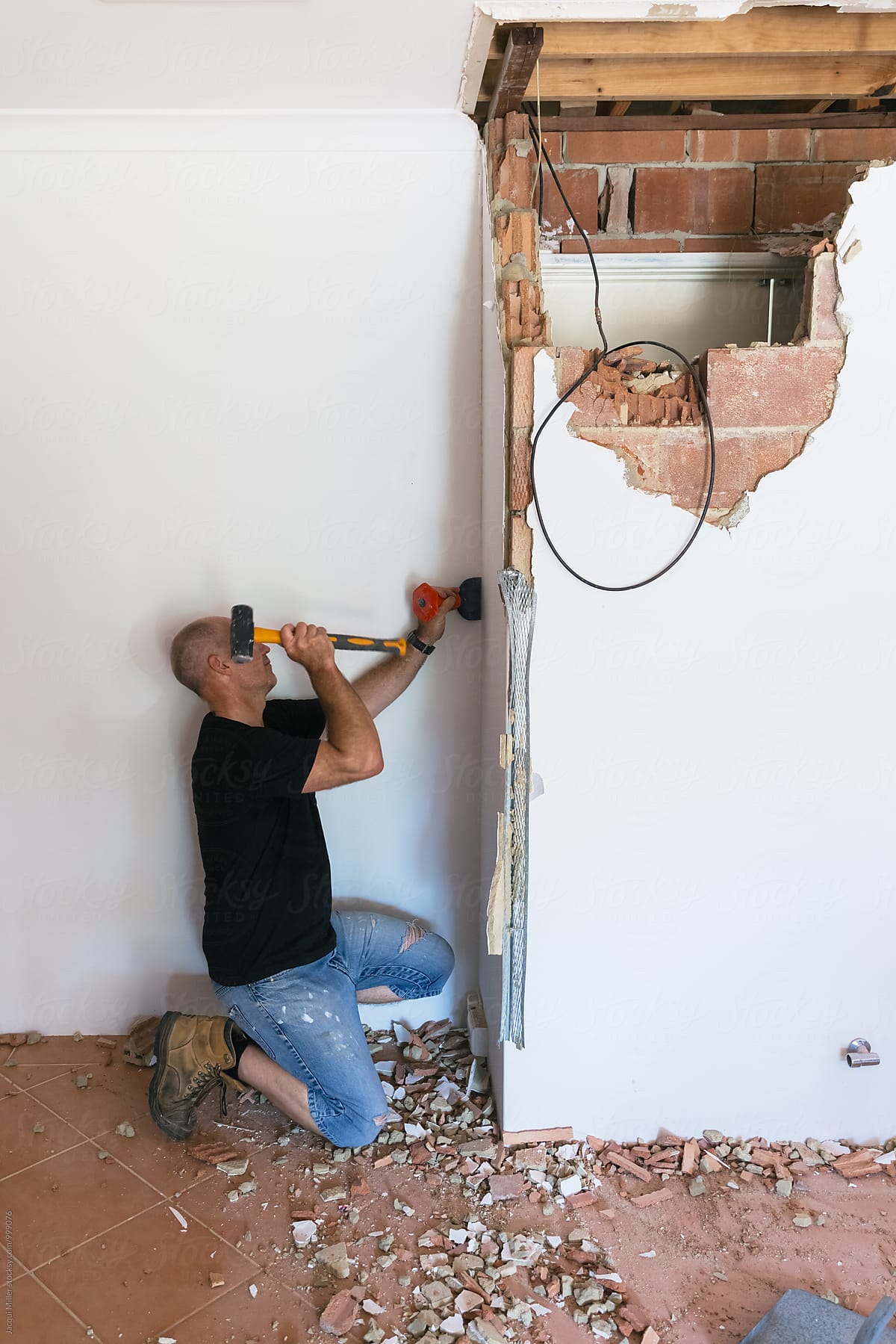 Home Renovator demolishing an internal brick wall