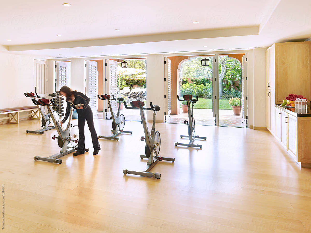 Spin class and instructor in exercise room at resort