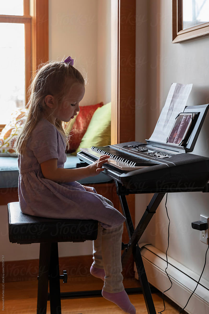 Young Child Learning to play Piano via Video chat